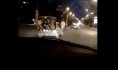 В легковушке ехали несколько парней, сидя вне салона.