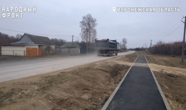 Грузовики с песком едут через село.